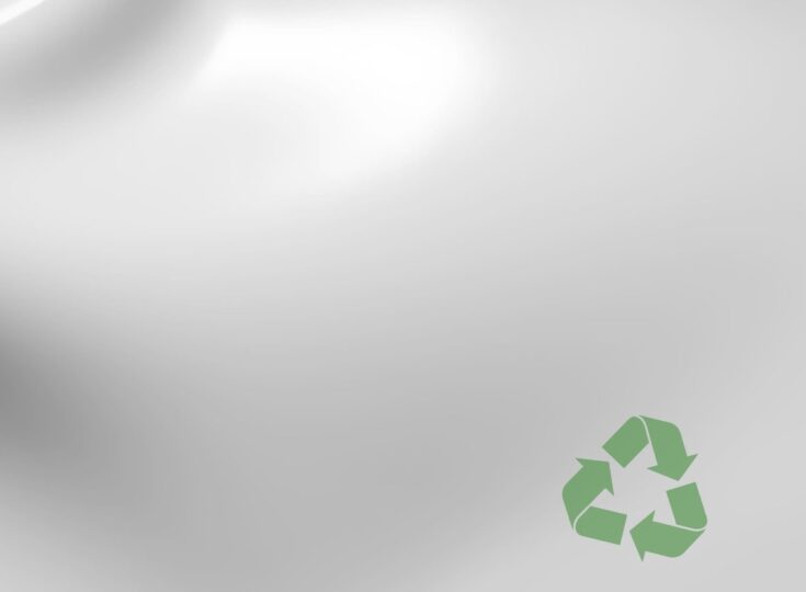 Close-up of white plastic with green recycle symbol.